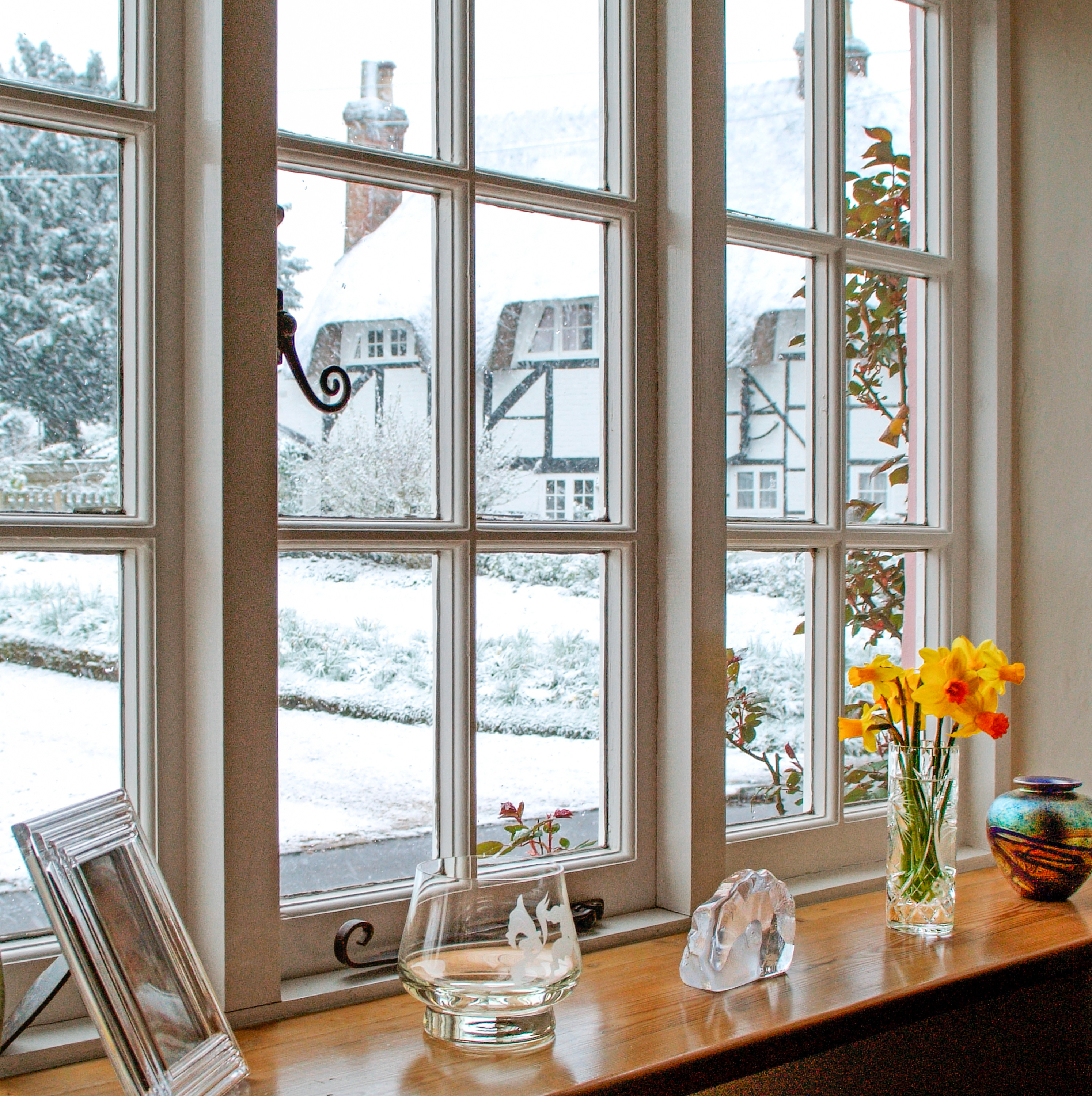 White framed windows with view of snow outside.